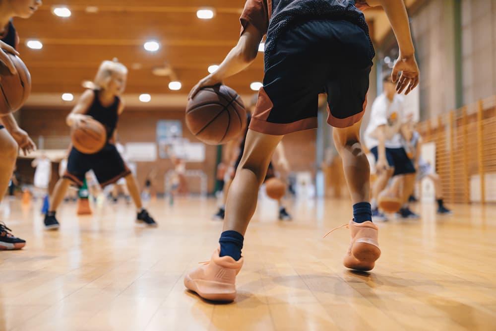 Young athlete performing sport-specific training drills with coach guidance, high energy sports photography